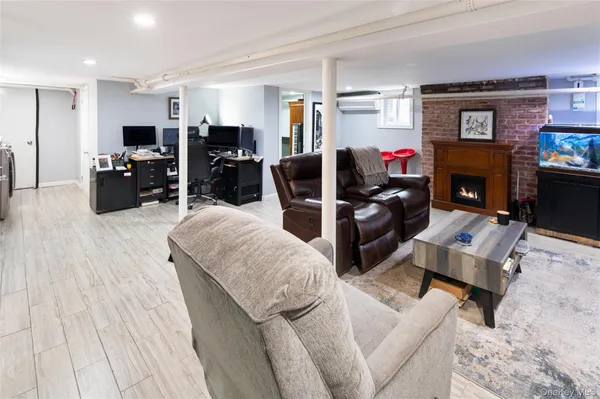 a living room with furniture a flat screen tv and a fireplace
