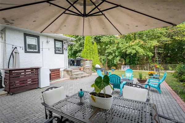an outdoor space with lots of furniture and garden