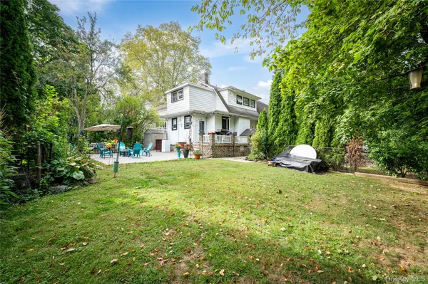 a view of a house with a tree in front
