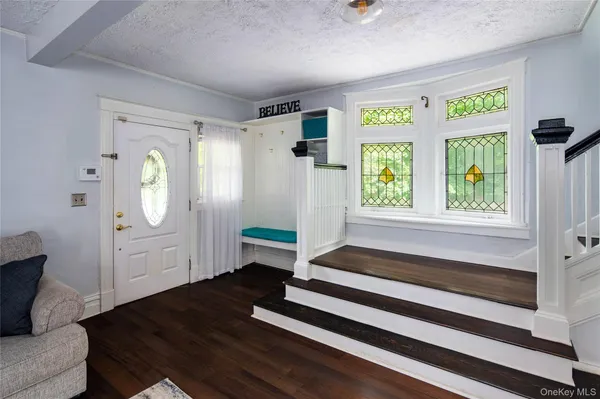 a living room with a bed furniture and a window