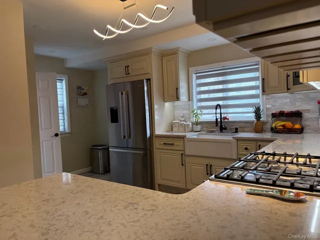 a kitchen with stainless steel appliances granite countertop a stove and a refrigerator