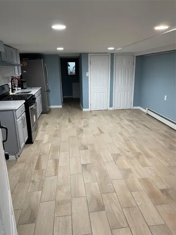 a view of a kitchen with a sink and a refrigerator