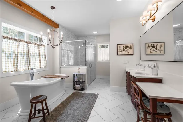 a bathroom with a granite countertop sink a toilet and shower
