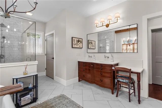 a living room with furniture two window and a flat screen tv