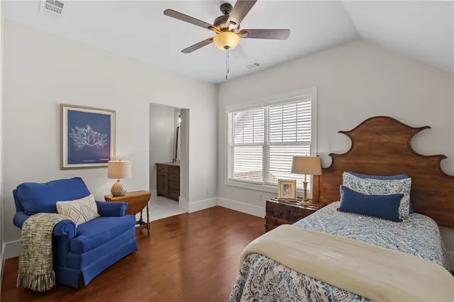 a kitchen with stainless steel appliances granite countertop a table chairs stove and wooden cabinets