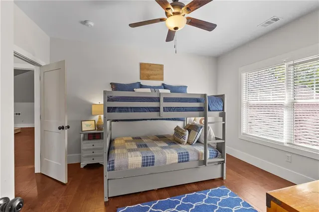 a kitchen with stainless steel appliances granite countertop a stove refrigerator and a fireplace with wooden floor