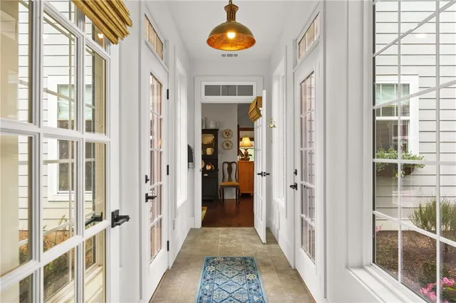 a spacious bathroom with a toilet a sink a mirror a shower a vanity and window