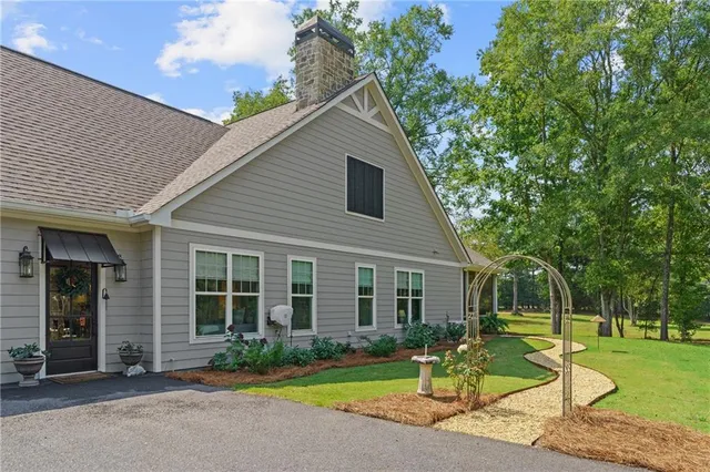 a bathroom with a granite countertop toilet sink and mirror