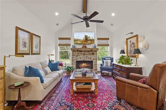 a living room with furniture a lamp and a window