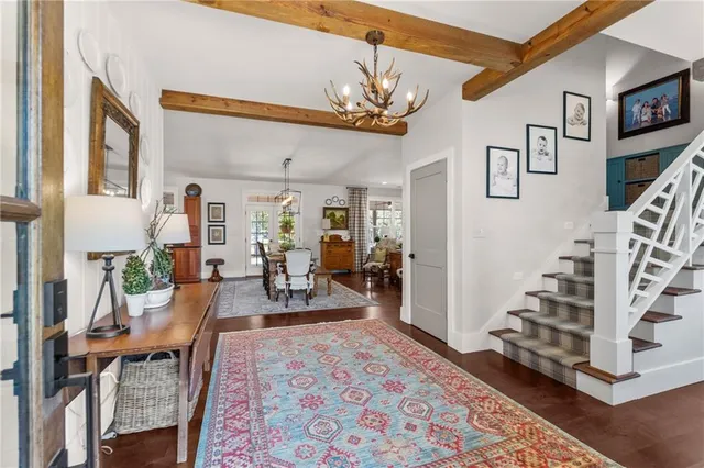 a living room with furniture and a chandelier