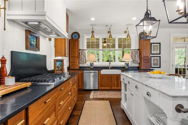 a kitchen with stainless steel appliances granite countertop a stove and a large refrigerator