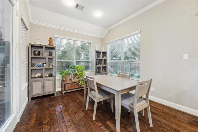 a dining room with furniture and a floor to ceiling window
