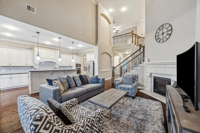 a living room with furniture a flat screen tv and a fireplace