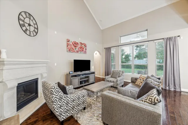 a living room with furniture a fireplace and a flat screen tv