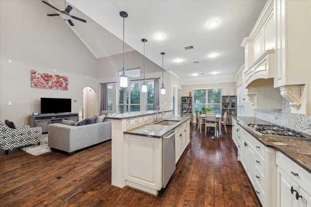 a kitchen with stainless steel appliances granite countertop a stove and a refrigerator
