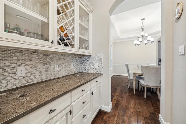 a hallway with sink and wooden floor