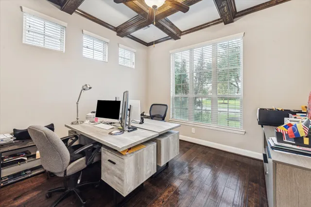 a view of a workspace with furniture and a window