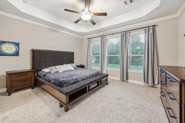 a bedroom with a bed and a large window with the outer view
