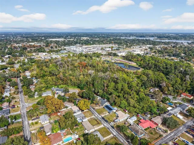 an aerial view of residential houses with city view and mountain view