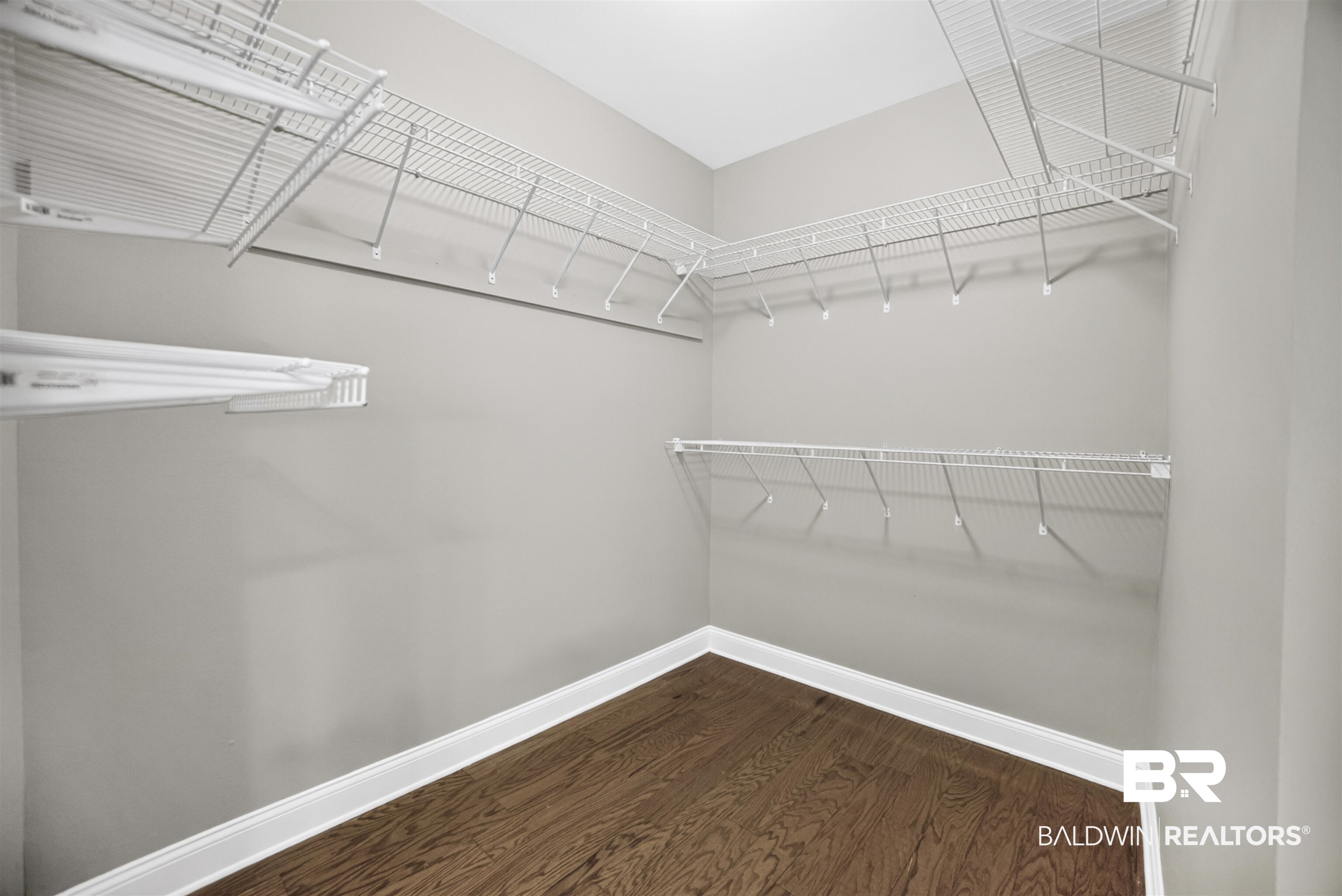 5913 Antoine Road Mobile, AL 36693 - Photo 16 of 33 Walk-in closet featuring wood-finish flooring, white wire shelving, and white baseboards