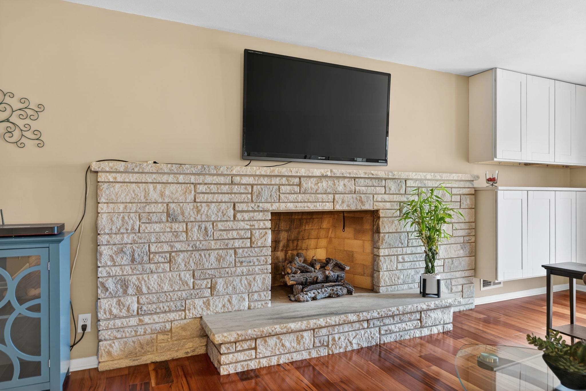 7681 Mill Road Rockford, IL 61108 - Photo 11 of 43 a living room with fireplace and a flat screen tv