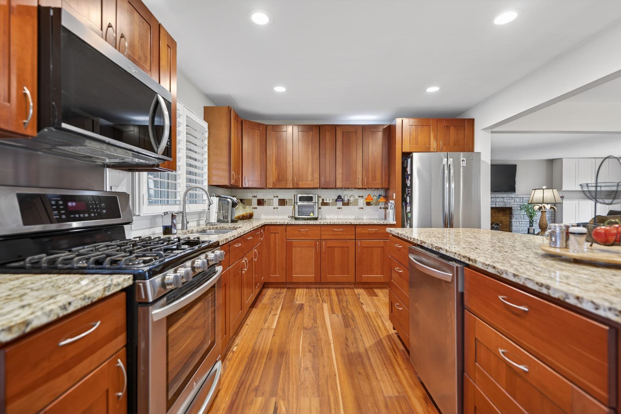 7681 Mill Road Rockford, IL 61108 - Photo 16 of 43 a kitchen with stainless steel appliances granite countertop a stove a sink and a microwave