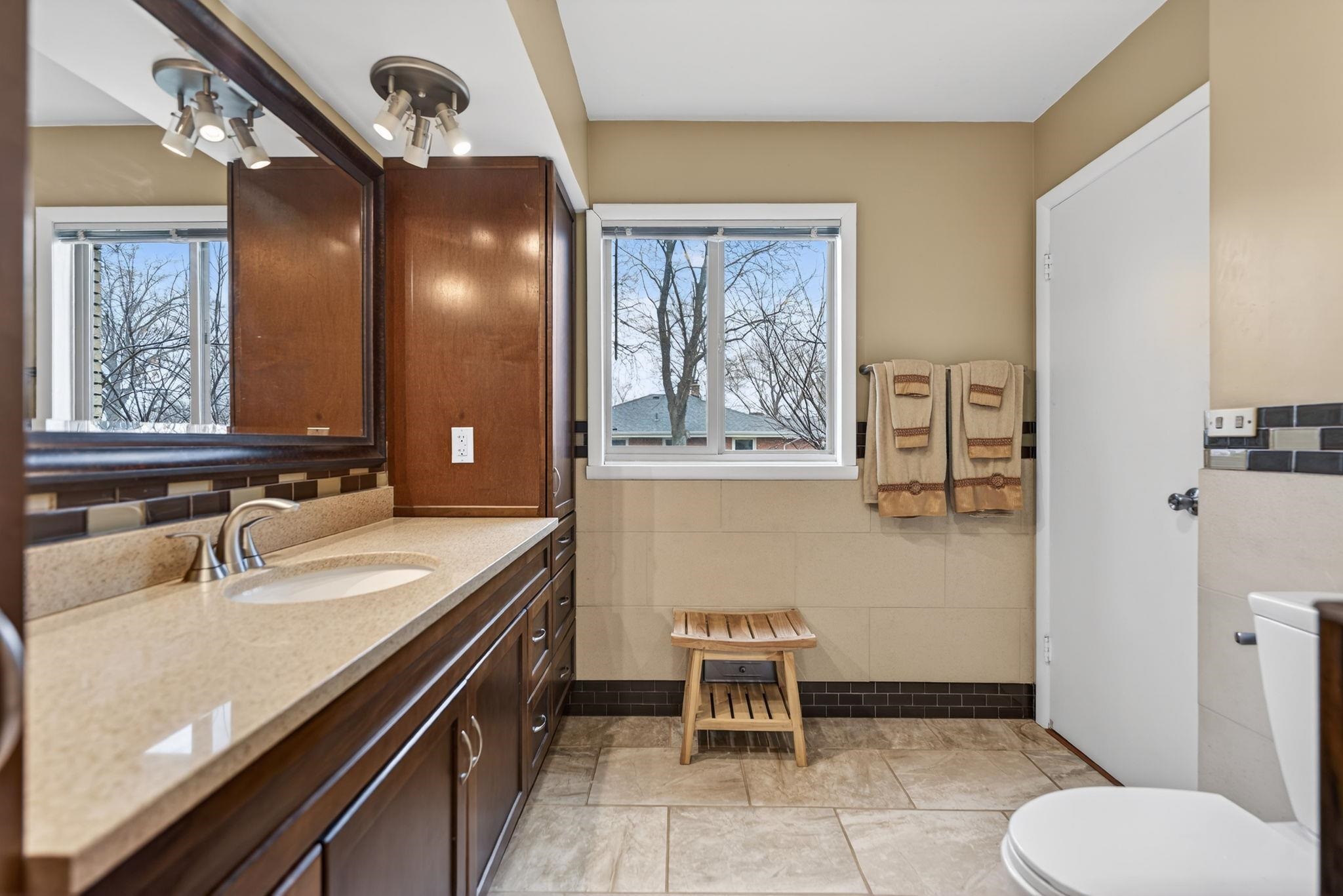7681 Mill Road Rockford, IL 61108 - Photo 27 of 43 a bathroom with a sink a toilet and a mirror