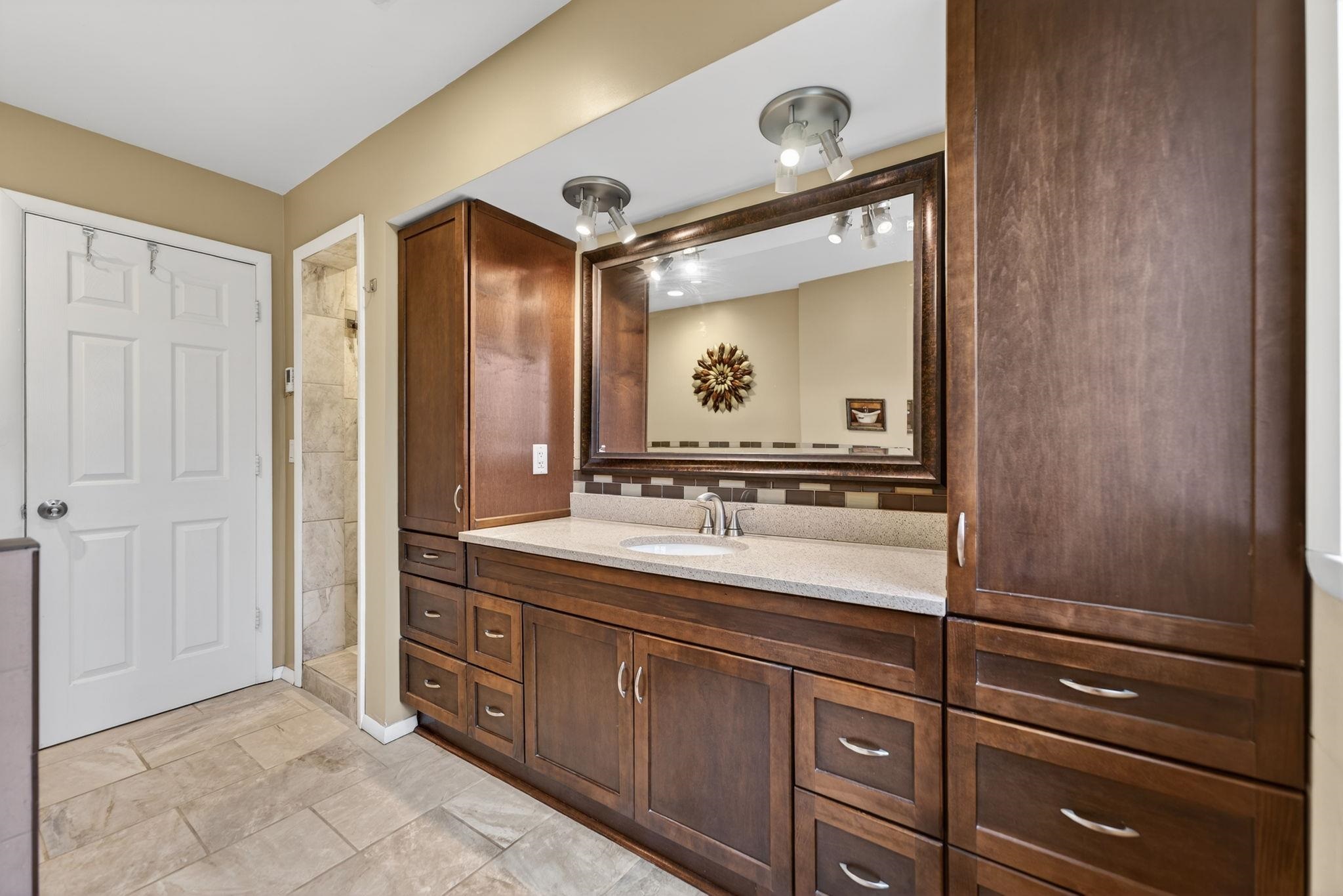 7681 Mill Road Rockford, IL 61108 - Photo 28 of 43 a bathroom with a granite countertop sink mirror and