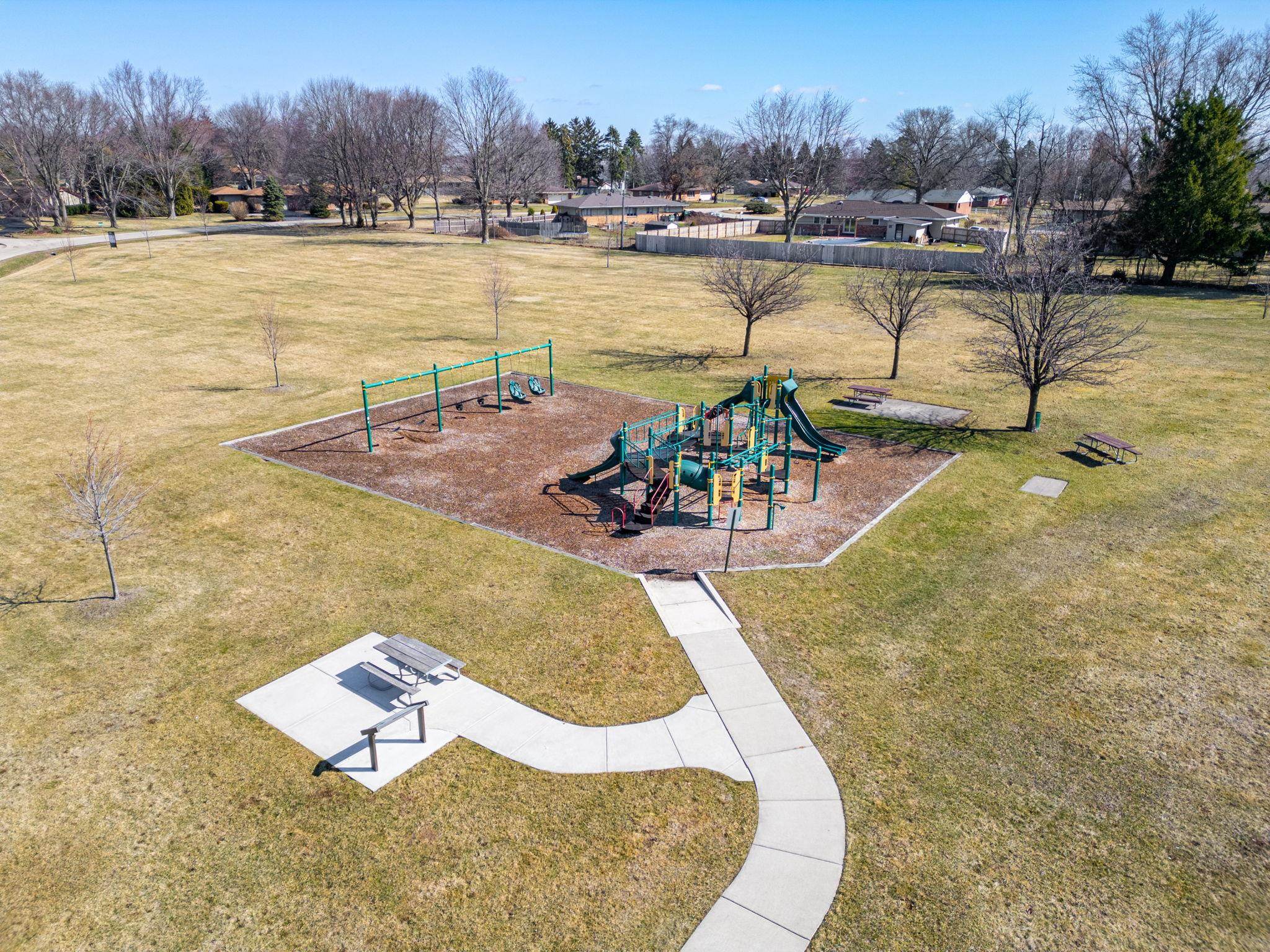 7681 Mill Road Rockford, IL 61108 - Photo 42 of 43 swimming pool with outdoor seating and trees in the background