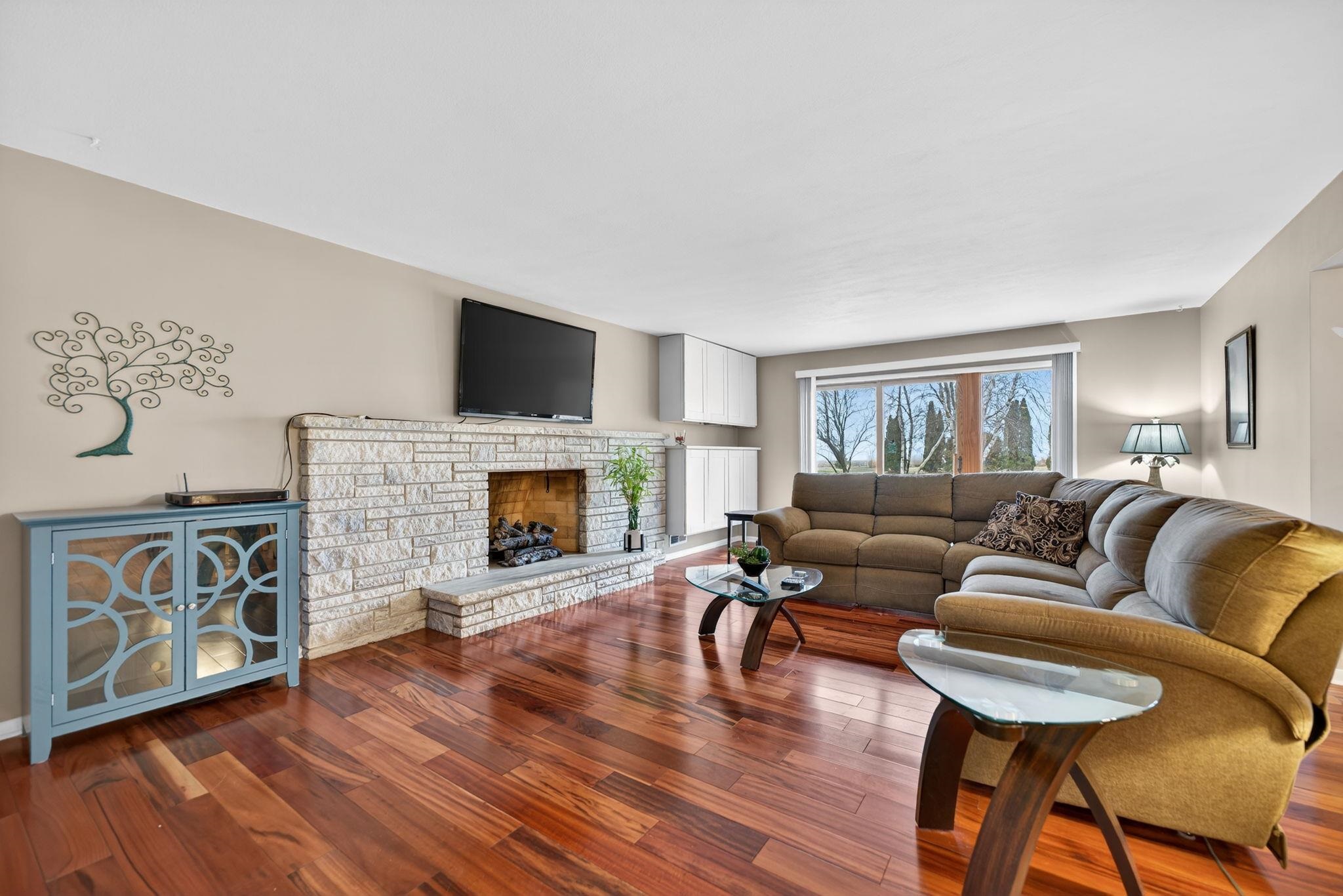 7681 Mill Road Rockford, IL 61108 - Photo 9 of 43 a living room with furniture a flat screen tv and a fireplace