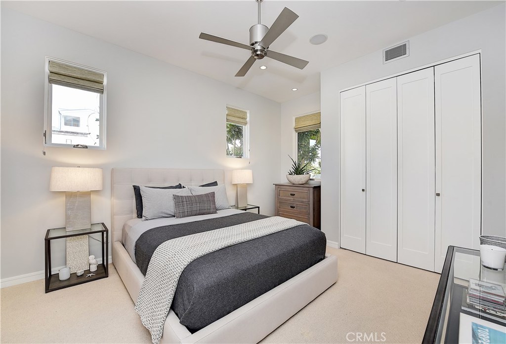 418 Carnation Avenue Corona del Mar, CA 92625 - Photo 15 of 29 a bedroom with a bed and a lamp