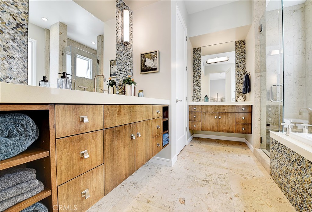 418 Carnation Avenue Corona del Mar, CA 92625 - Photo 16 of 29 a spacious bathroom with a tub a double vanity sink and mirror