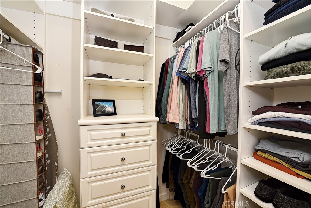 418 Carnation Avenue Corona del Mar, CA 92625 - Photo 19 of 29 a view of walk in closet with clothes and shoes