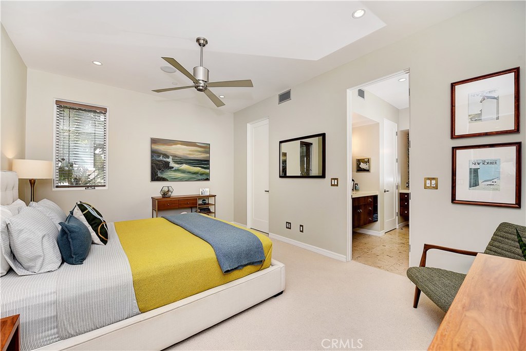 418 Carnation Avenue Corona del Mar, CA 92625 - Photo 22 of 29 a bedroom with a large bed and a chandelier