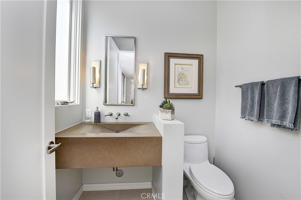 418 Carnation Avenue Corona del Mar, CA 92625 - Photo 24 of 29 a bathroom with a sink toilet and mirror