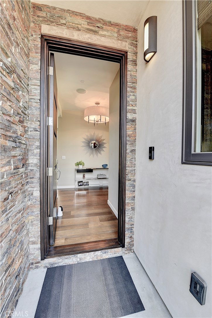 418 Carnation Avenue Corona del Mar, CA 92625 - Photo 26 of 29 a view of a hallway with wooden floor and a living room