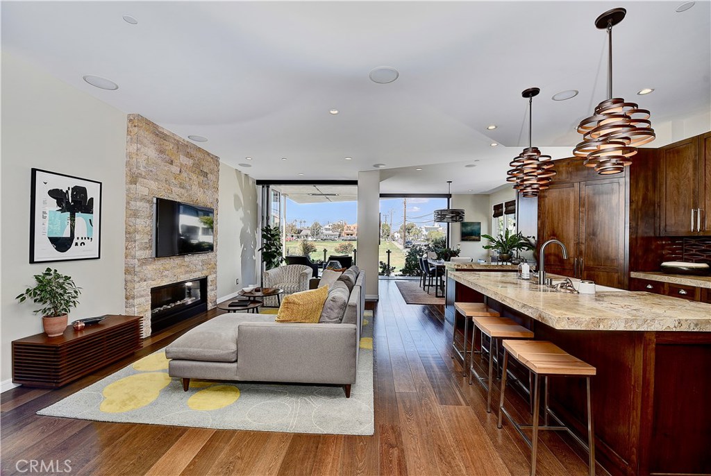 418 Carnation Avenue Corona del Mar, CA 92625 - Photo 4 of 29 a living room with furniture flat screen tv and a fireplace