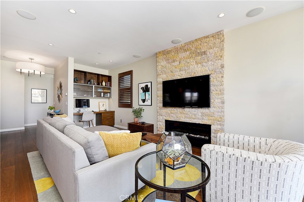 418 Carnation Avenue Corona del Mar, CA 92625 - Photo 6 of 29 a living room with furniture flat screen tv and a fireplace