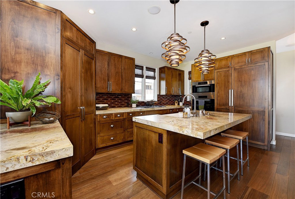 418 Carnation Avenue Corona del Mar, CA 92625 - Photo 9 of 29 a kitchen with a table and chairs in it