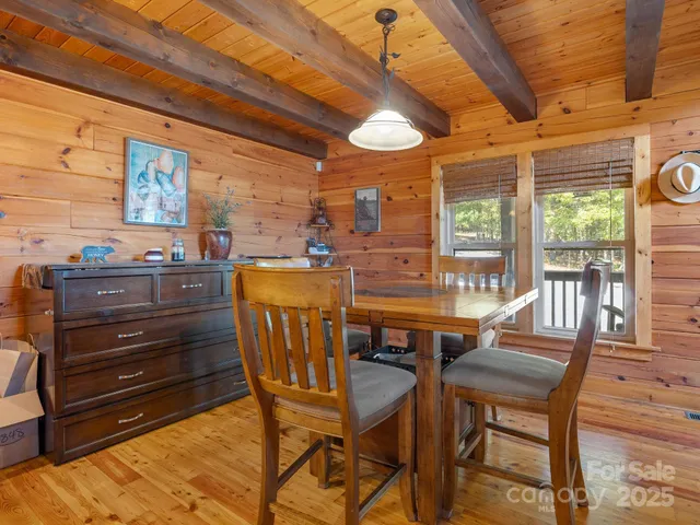 a dining room with furniture and wooden floor