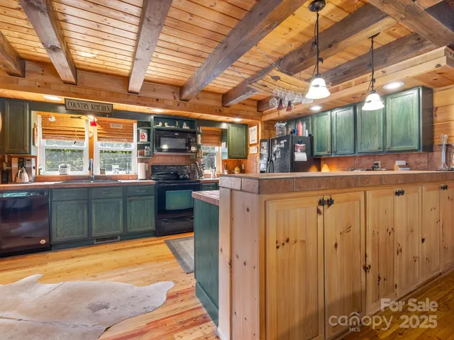a kitchen with kitchen island a stove a sink and a microwave