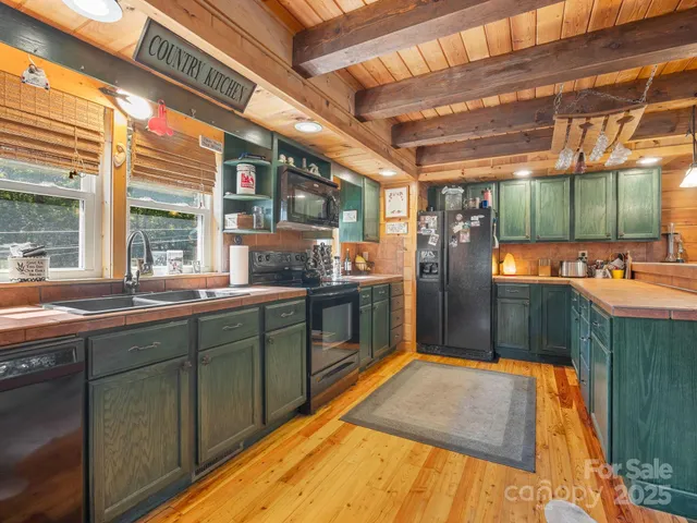 a kitchen with stainless steel appliances granite countertop a sink and wooden cabinets