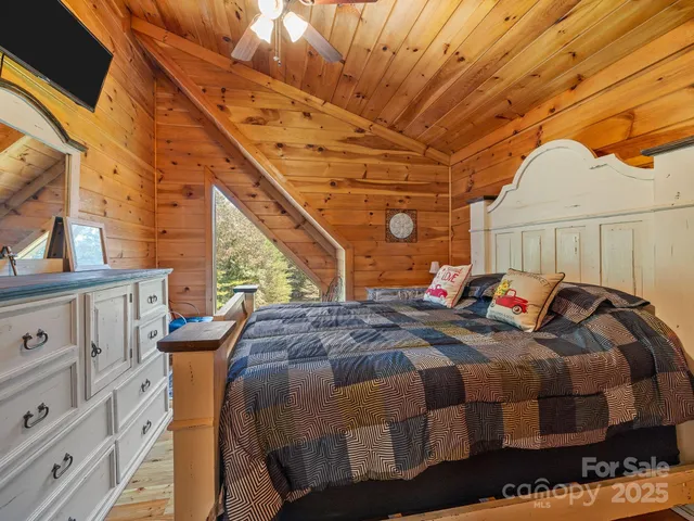 a bed sitting in a bedroom next to a larger window