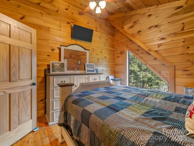 a bed sitting in a bedroom next to a window