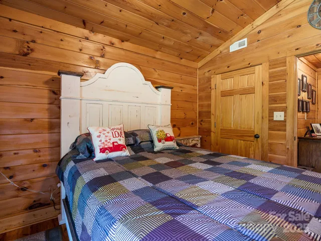 a bed sitting in a bedroom next to a window