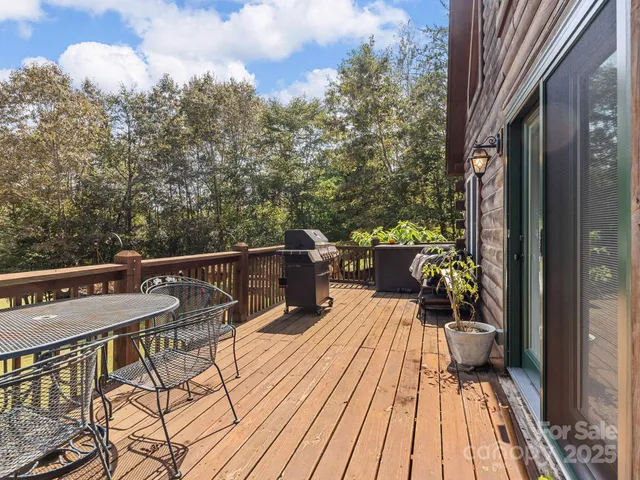 a view of a balcony with chairs and wooden floor