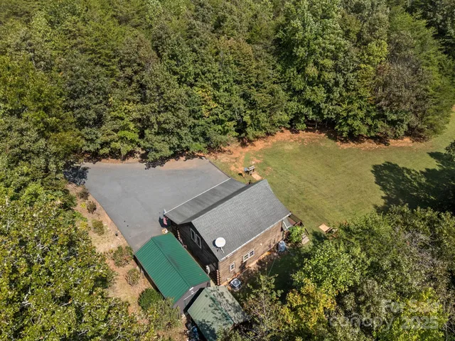 an aerial view of house with yard swimming pool and outdoor seating