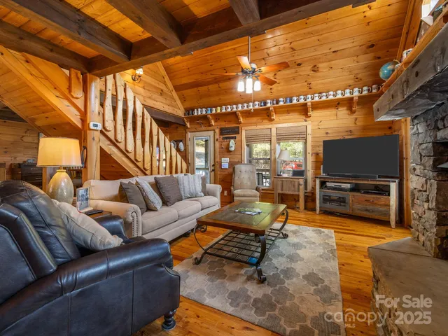 a living room with furniture a flat screen tv and a table