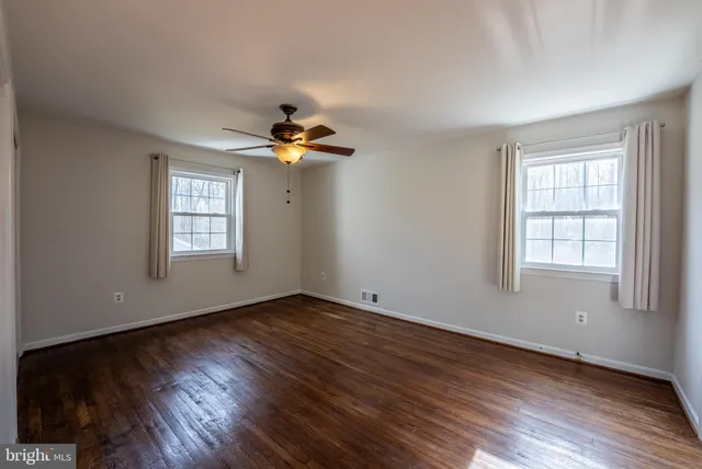 a bathroom with a shower sink vanity mirror and toilet