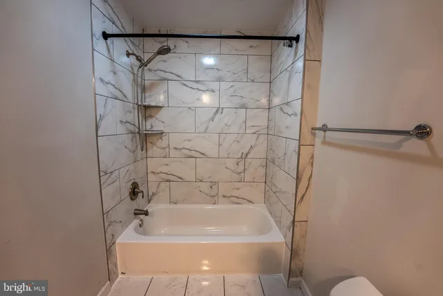 a view of a empty room with wooden floor